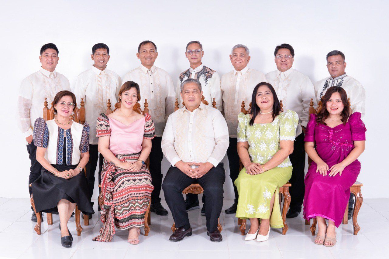 The members of the Sangguniang Bayan ng Pinamalayan, seated and standing in formal Filipino attire.
